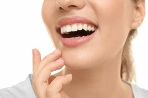 Young woman smiling after receiving dental bonding