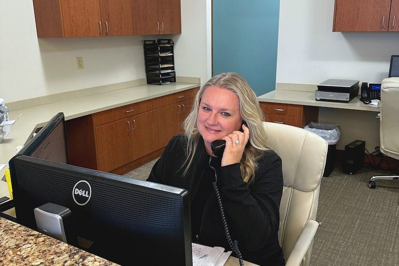 Young man in black shirt shaking hands with dentist
