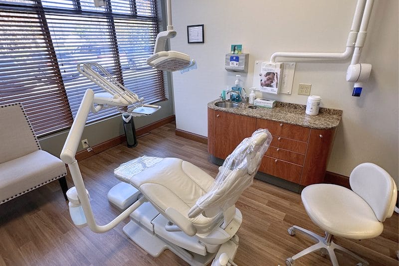 Young man in black shirt shaking hands with dentist